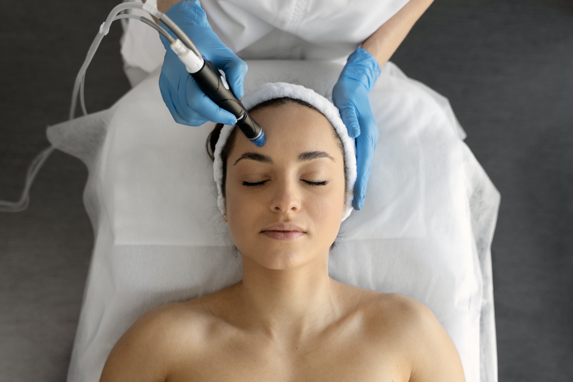Female at cosmetic beauty spa clinic has facial hardware cosmetology